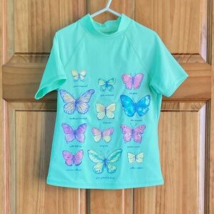 Girl’s size 7-8 Lands’ End short sleeved green butterflies swim top, swim shirt